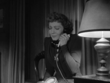 Anne Hilton (Claudette Colbert) receiving the cable gram that her husband is home safe. -screen capped by the Hollywood Comet