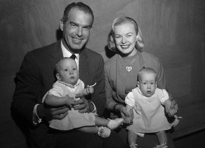 Fred MacMurray and wife June Haver with their adopted twin baby girl Laurie Ann and Katherine Marie in 1956