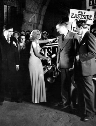 Celebrating the end of Prohibition, Harlow christens a truck load of beer in 1933. Pictured with Walter Huston.