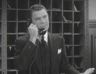 John Ridgely as a hotel clerk in 