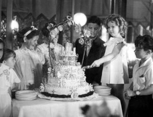 Shirley Temple cutting the cake at her birthday party in 1935.