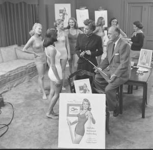 Williams looks over a Cole of California bathing suit. She allowed the company to use her name for a bathing suit line in 1951. (LIFE/Edward Clark)