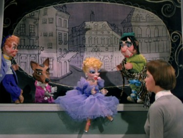Leslie Caron as Lili talks with puppets