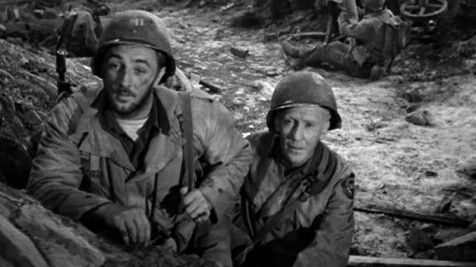 Robert Mitchum and Burgess Meredith (as Ernie Pyle) in World War II film "The Story of G.I. Joe" about reporting on the front lines.