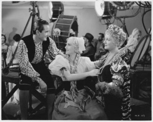 Nino Martini, Joan Fontaine, and Lee Patrick (left to right) work as Hollywood film extras in "Music for Madame."