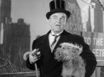 Homeless McKeever (Victor Moore) dressed in Michael O'Connor's clothes as he stays in his home.