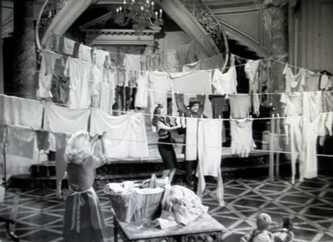 Wives of Jim's Army buddies use the foyer of the O'Connor home for hanging laundry as the house gets more crowded.