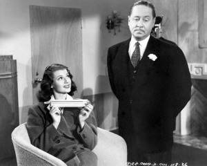 Robert Benchley tries to woo Rita Hayworth with a bracelet in "You'll Never Get Rich"