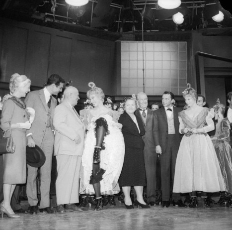 Shirley MacLaine performs like a Can Can girl for Soviet Premier Nikita Khrushchev at the 20th Century Fox Studios. Left to right: Louis Jourden, Mr. Khrushchev, Shirley MacLaine, Mrs. Khrushchev, Maurice Chevalier, and Frank Sinatra.