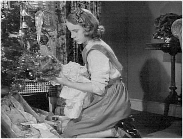 Peggy Ann Garner with the doll on Christmas morning 