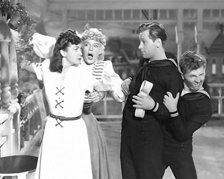 Bessie (Hutton) holds back the Countess (Lamour) when she finds out there is a bet if Casey (Holden) kisses her. Barney (Bracken) hides.