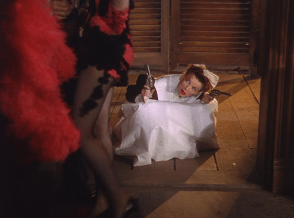 Judy Garland going into the saloon with guns to steal back the steaks in "The Harvey Girls."