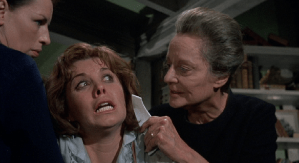 Mrs. Trefoile threatens to cut Patricia's face so she will no longer be attractive to men. Maid Kate holds Patricia so she can't escape. 