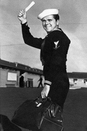 Jackie Cooper when he was discharged in 1946.  Original caption: Joyously waving his discharge paper, movie actor Jackie Cooper prepares to depart for Hollywood after leaving Navy separation center at Terminal Island, Long Beach. Cooper served 26 months and was discharged with rank of Musician, 3rd class. 