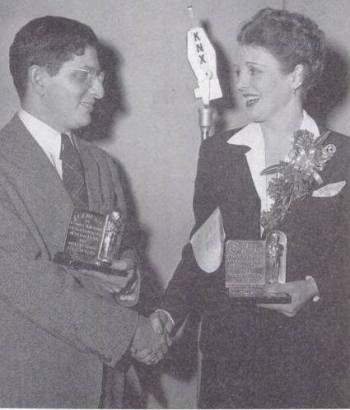 Actress Mary Astor presents Bernard Herrmann with the Academy Award for Best Score for "All That Money Can Buy." 