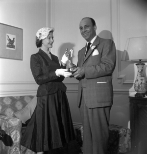 Vivien Leigh accepting her Best Actress award for A Streetcar Named Desire from Harry Cohn in London, England