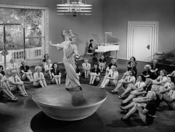 Betty Jane Cooper dances on a platform and is surrounded by girls watching